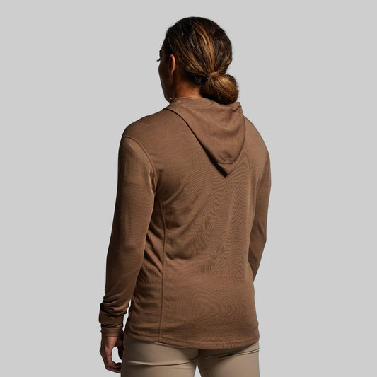 Person wearing a brown hoodie on a plain background