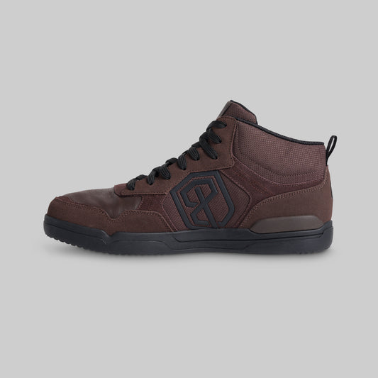 A dark brown high-top sneaker with black laces, a black outsole, and a black geometric logo on the side, shown against a solid gray background.