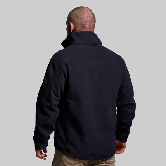 Man wearing a blue jacket on a gray background