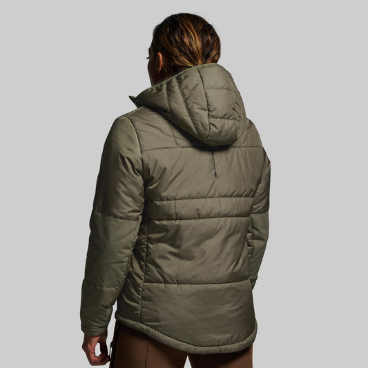 Person wearing a green puffer jacket on a gray background