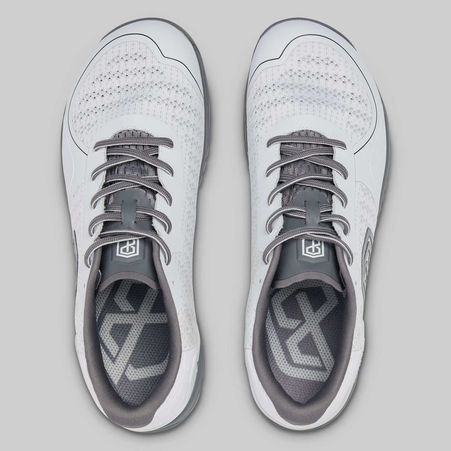White and gray athletic shoes on a light gray background