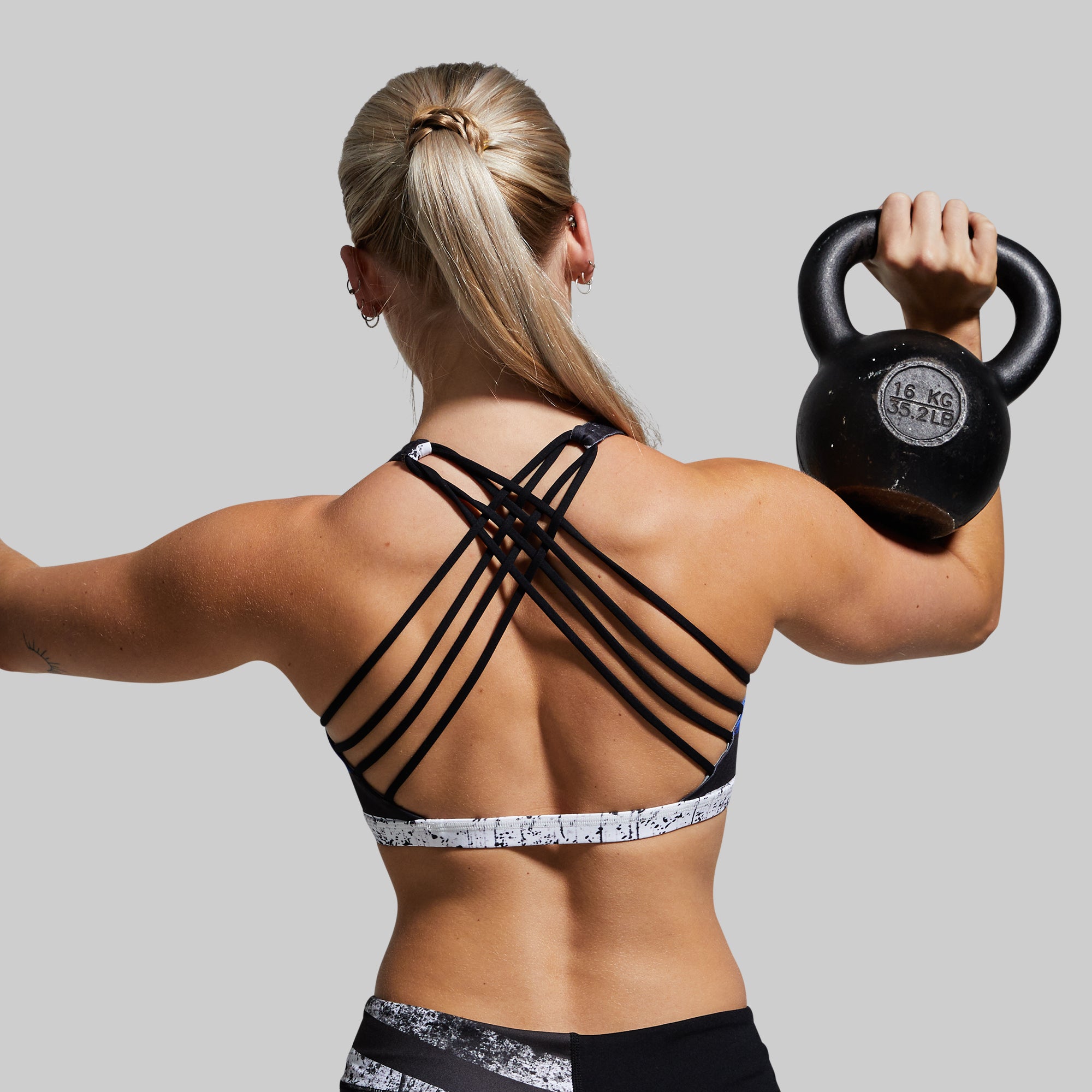 Placeit - Sports Bra Mockup of a Woman Lifting Dumbbells