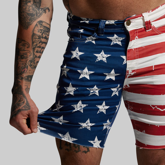 Person wearing American flag patterned shorts on a plain background
