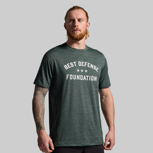 Man wearing green t-shirt with "Best Defense Foundation" printed on the front.