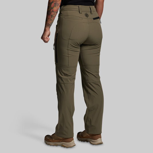Person wearing olive green outdoor pants on a gray background