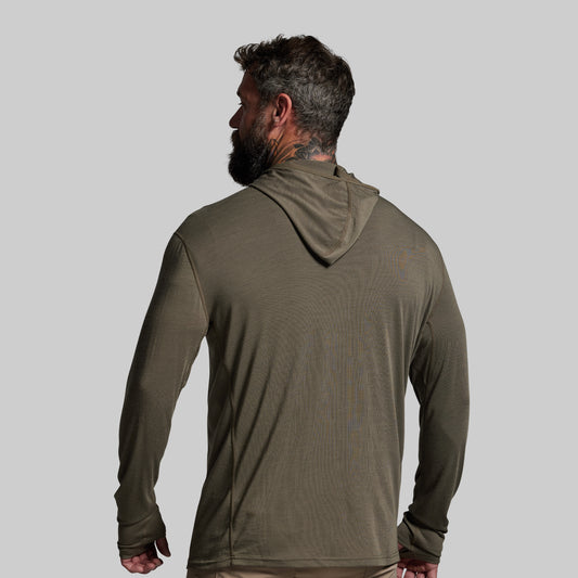 Man wearing a green hoodie from behind on a gray background