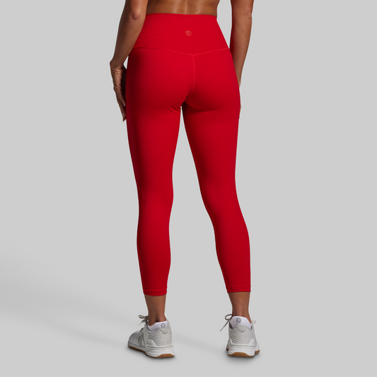 Person wearing red leggings on a gray background