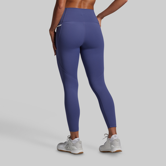 Person wearing purple leggings on a gray background