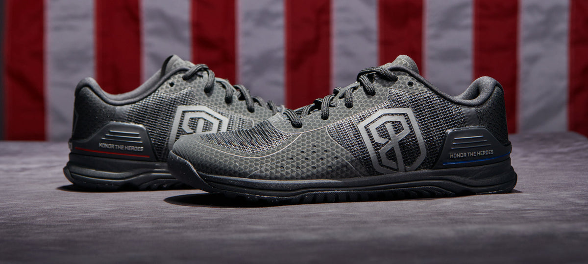 Metal grey 9/11 25th Anniversary Savage 1 training shoes displayed in front of an American flag
