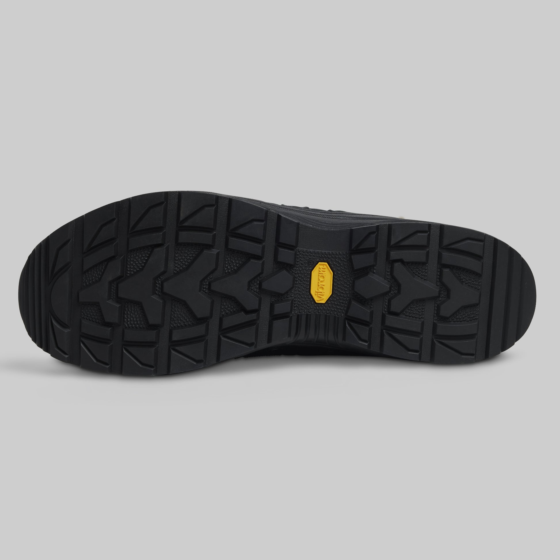 Black shoe sole with a brand logo on a gray background