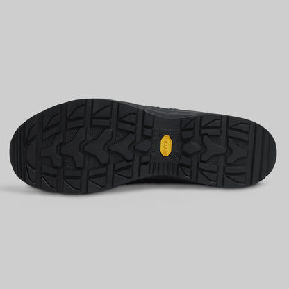 Black shoe sole with a brand logo on a gray background