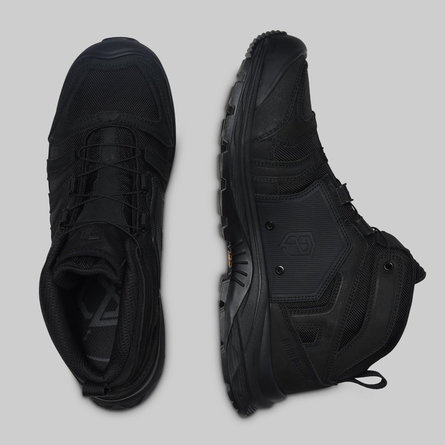 Pair of black boots on a light gray background