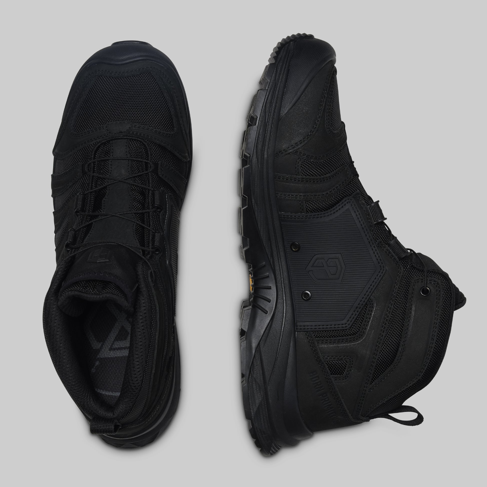 Pair of black boots on a light gray background