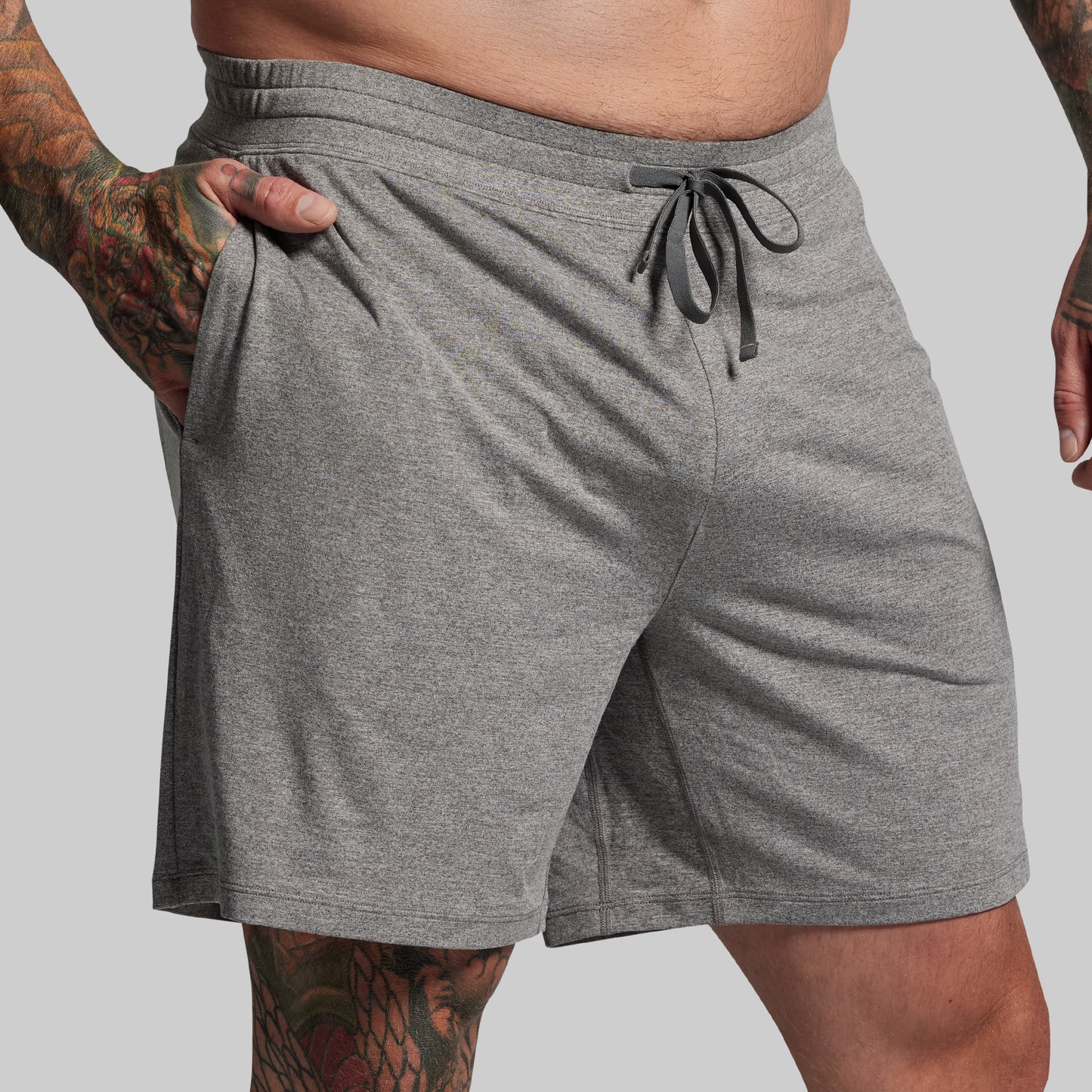 Gray shorts with drawstring on a plain background