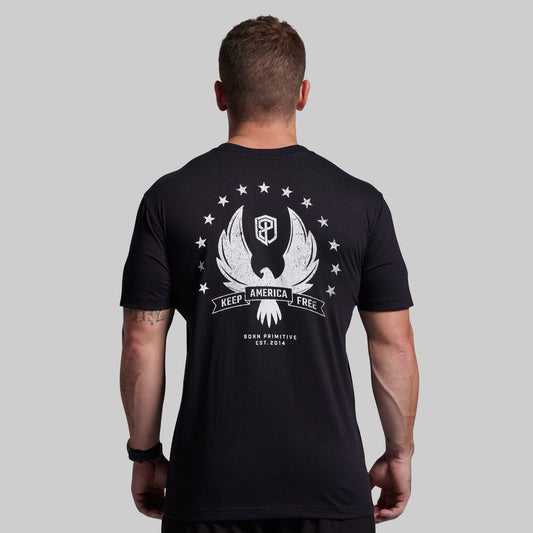 Man wearing a black t-shirt with a white graphic design on the back against a gray background