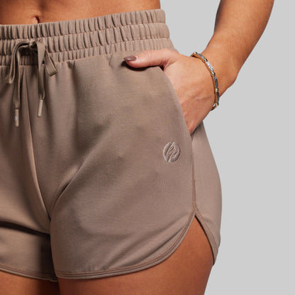Brown shorts with a logo on a plain background
