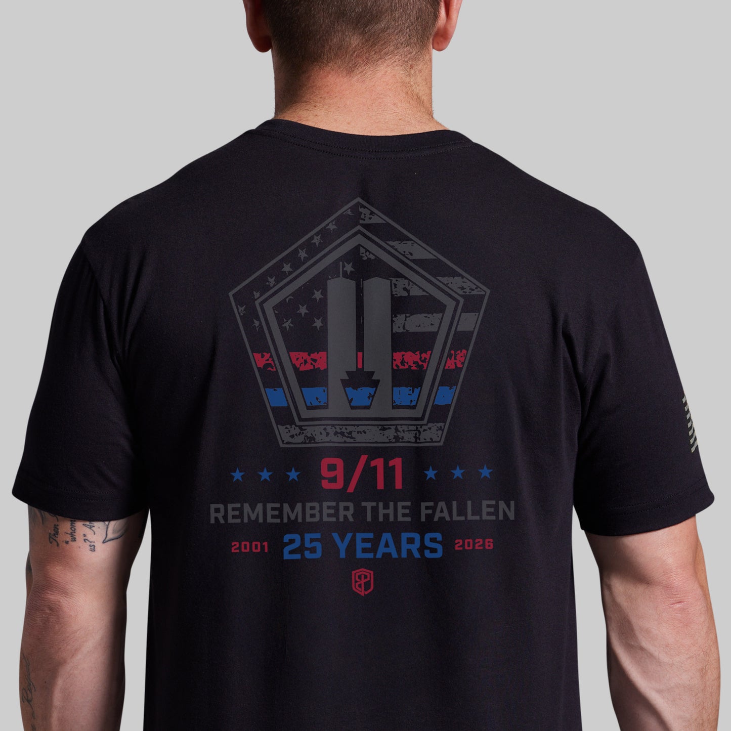 Man wearing a black 9/11 25th Anniversary tee, back with Remember the Fallen 2001-2026 graphic
