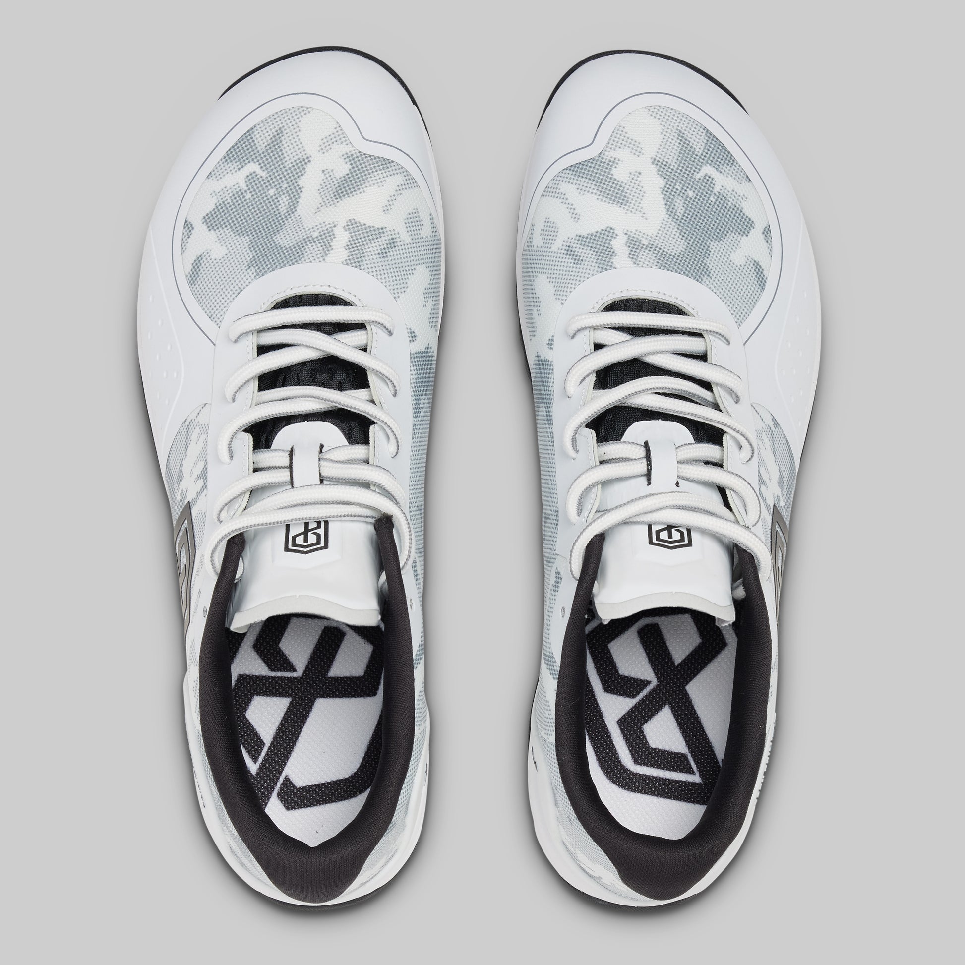 White athletic shoes with black accents on a gray background