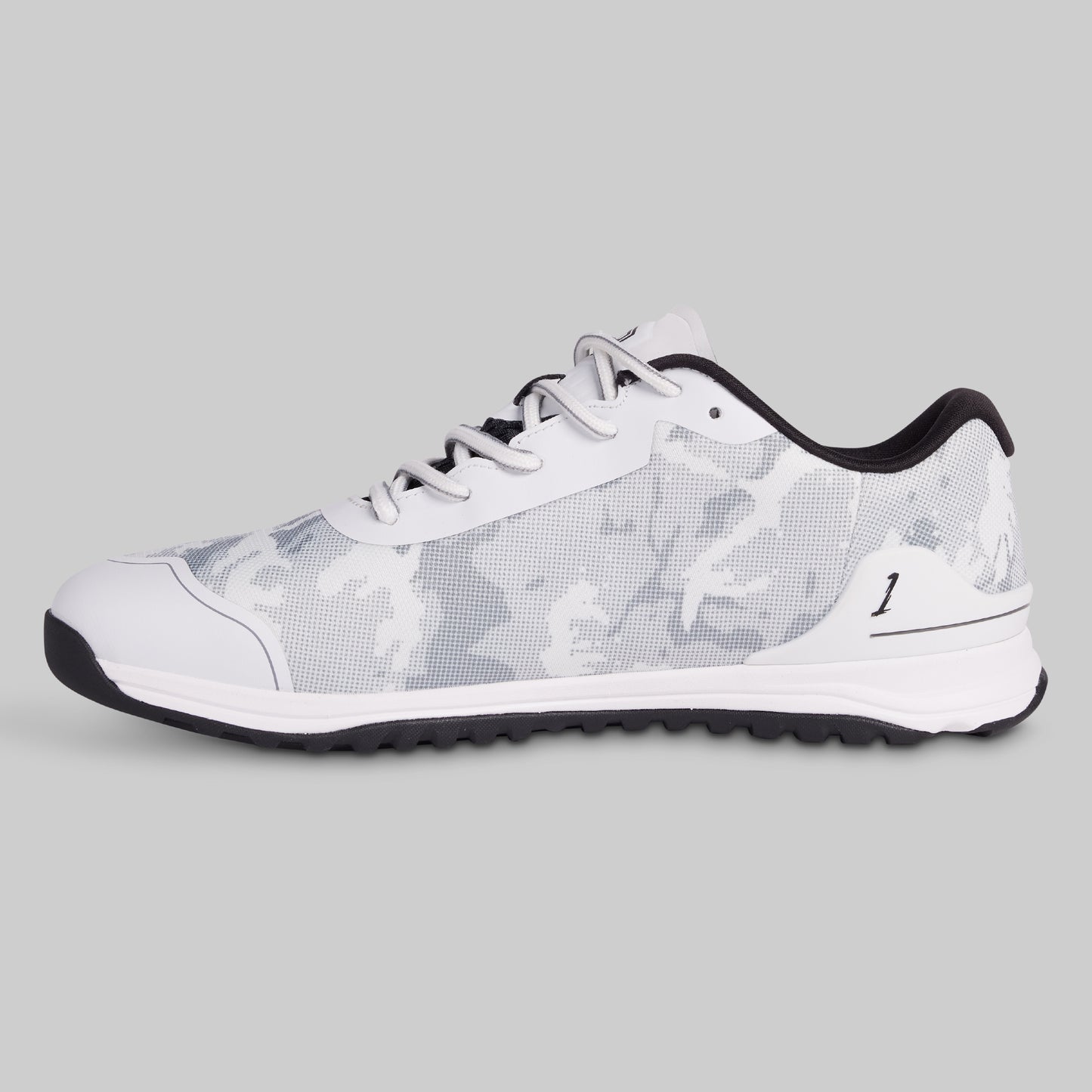 White sneaker with black sole on a gray background