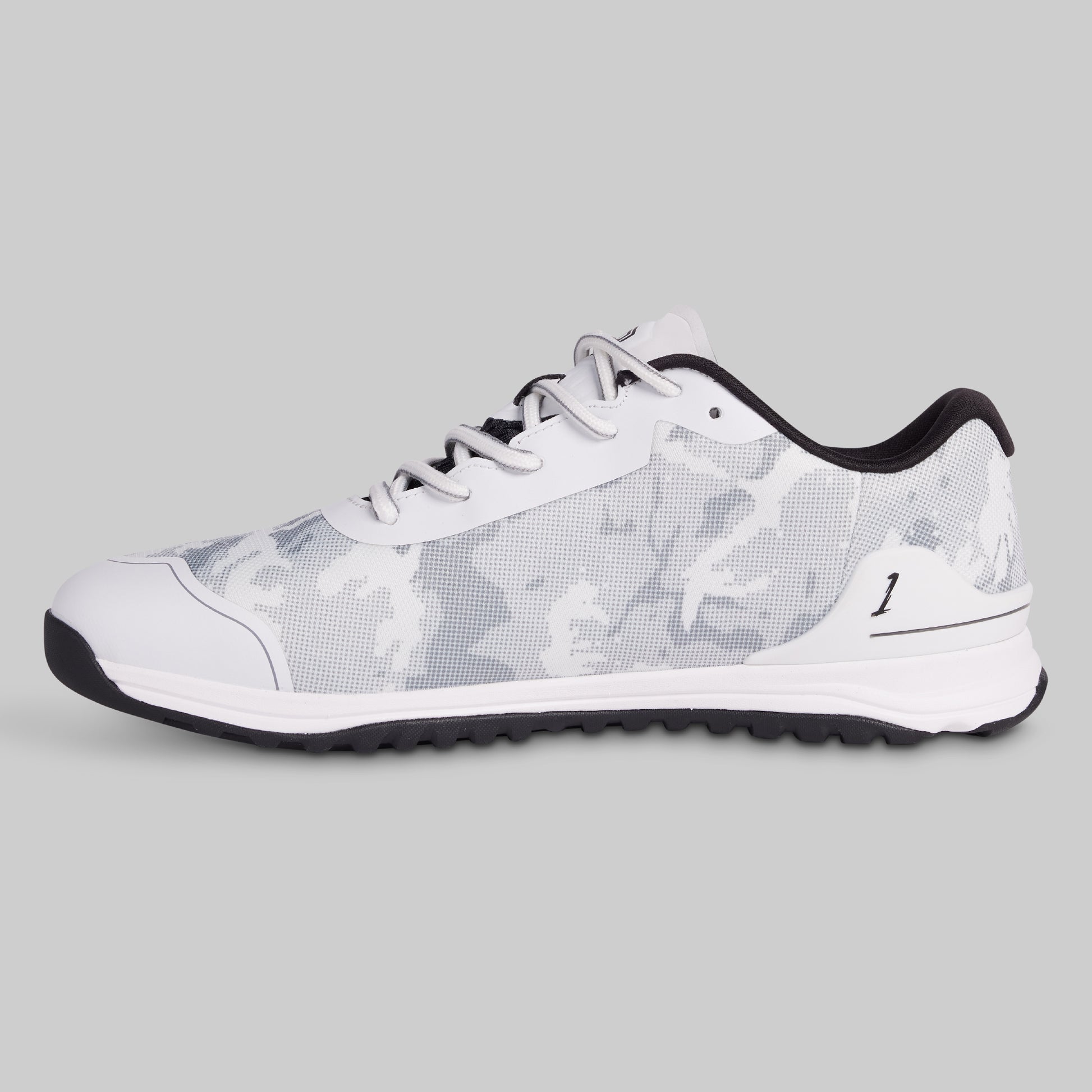 White sneaker with black sole on a gray background