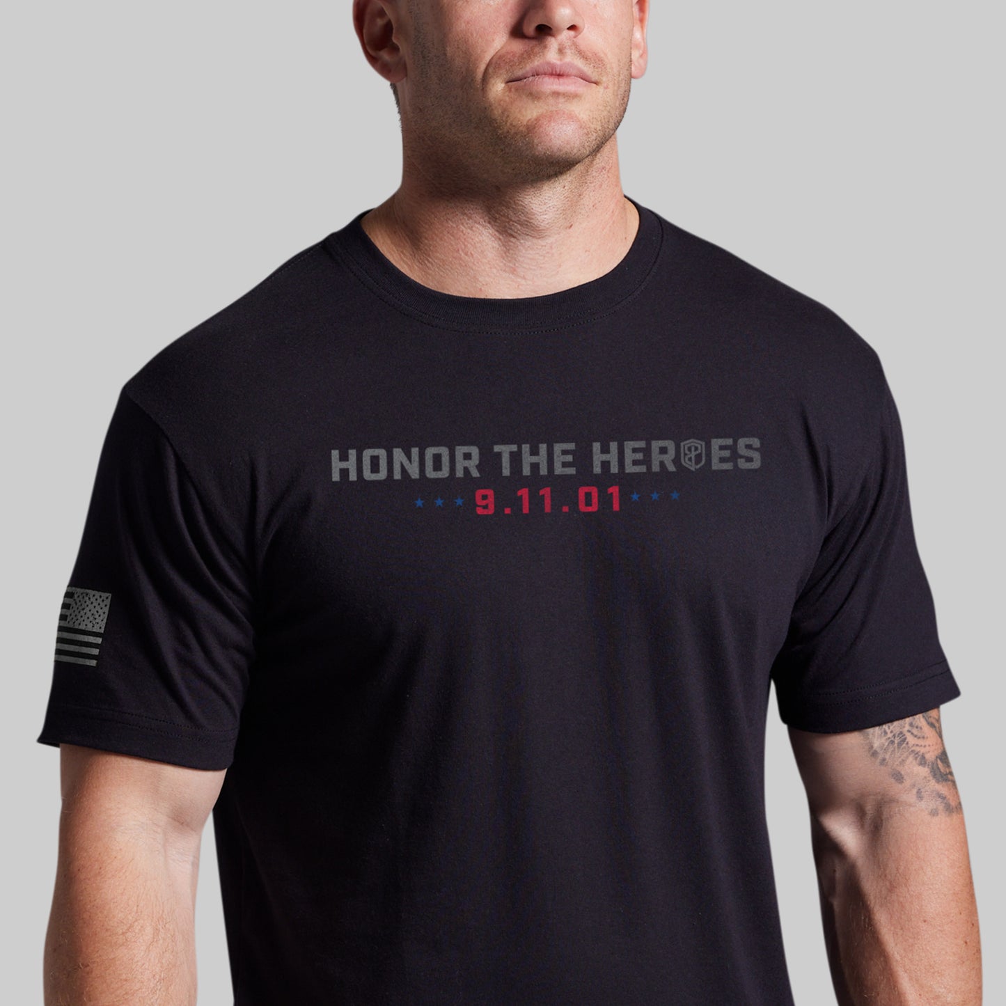 Man wearing a black 9/11 25th Anniversary tee, front with Honor the Heroes and 9.11.01 graphic