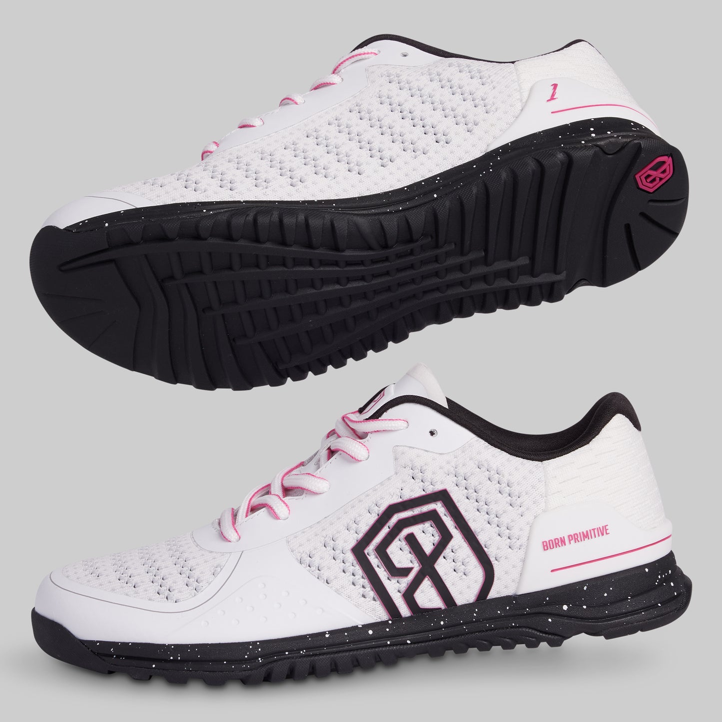 White athletic shoes with black soles and pink accents on a light gray background