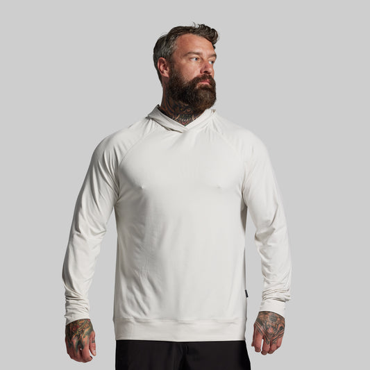 Man wearing a white hoodie against a gray background