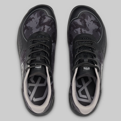 Black and gray athletic shoes on a light gray background