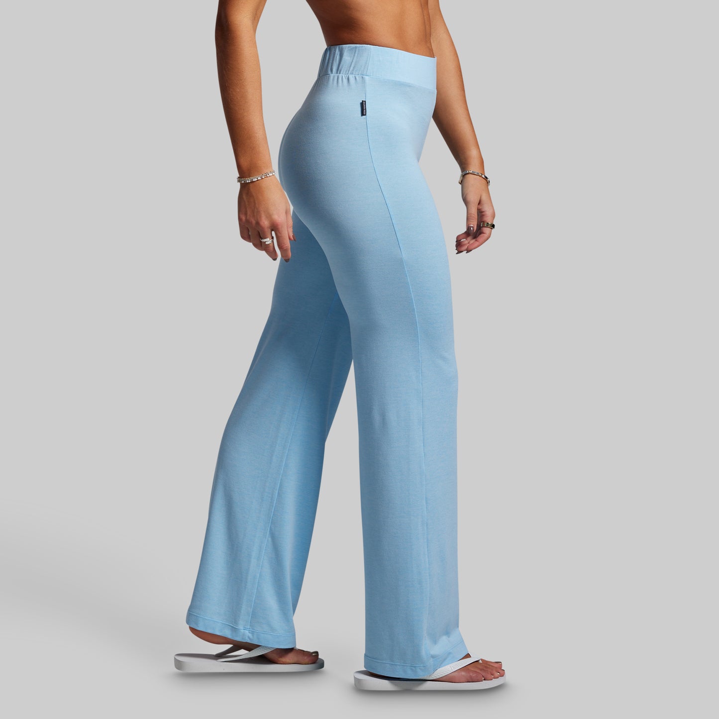 Light blue wide-leg pants worn by a person on a gray background