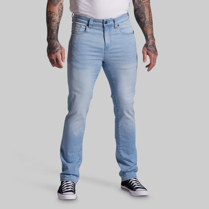 Person wearing light blue jeans on a gray background