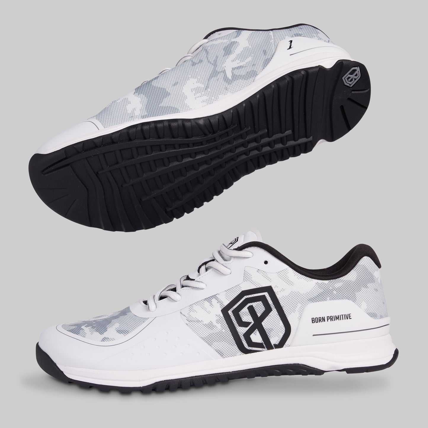 White athletic shoes with black soles and a logo on a gray background