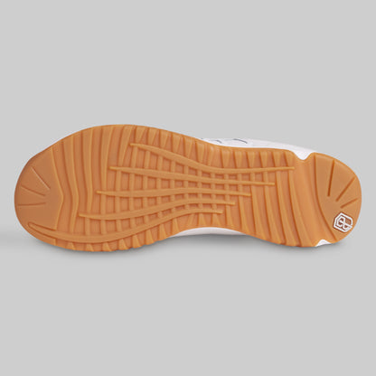 Close-up of a shoe sole with a textured pattern on a gray background