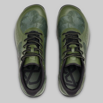 Pair of green athletic shoes with black accents on a light gray background