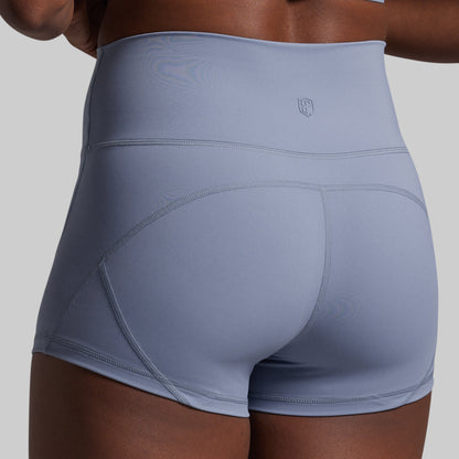 Light blue athletic shorts worn by a person on a gray background