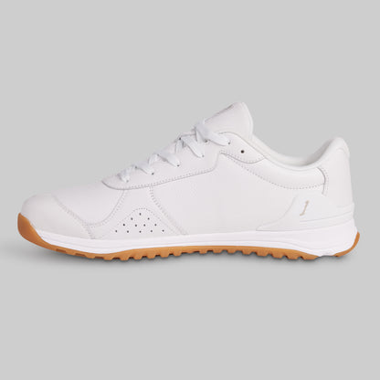 White sneaker with brown sole on a light gray background