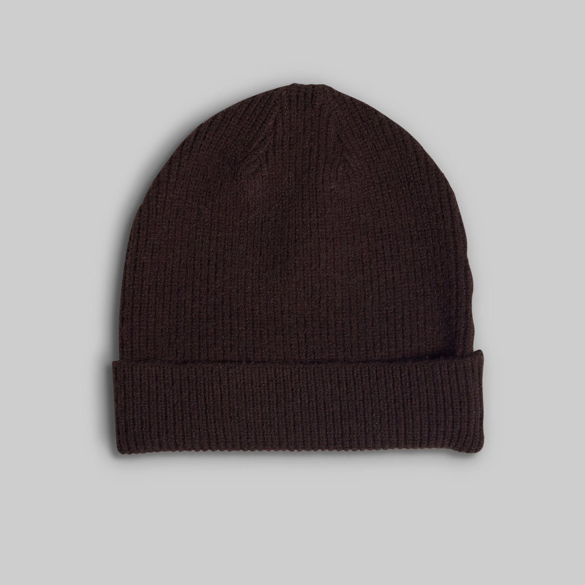 A dark brown ribbed knit beanie hat with a folded cuff, shown against a solid light gray background.