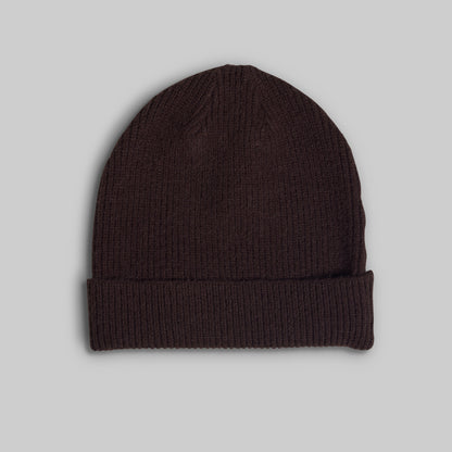 A dark brown ribbed knit beanie hat with a folded cuff, shown against a solid light gray background.