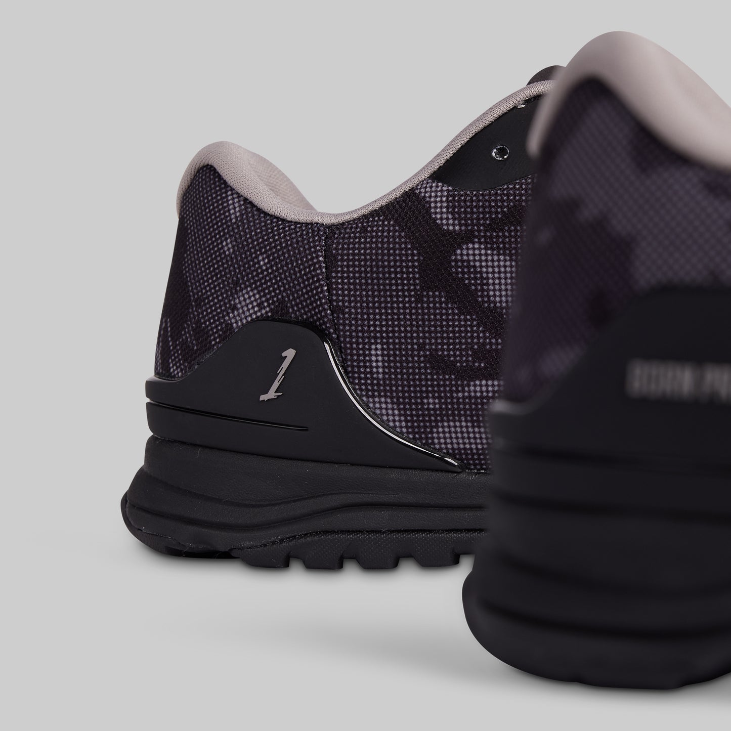 Black athletic shoe on a light gray background