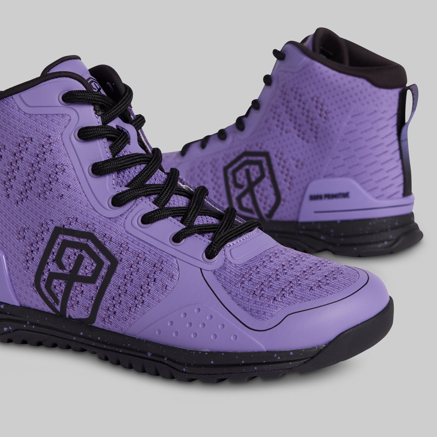 Purple high-top sneakers with black accents on a light gray background
