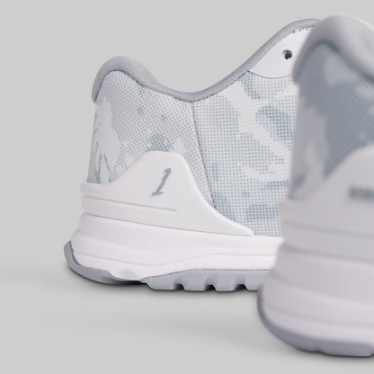Close-up of a white sneaker with gray accents on a light gray background