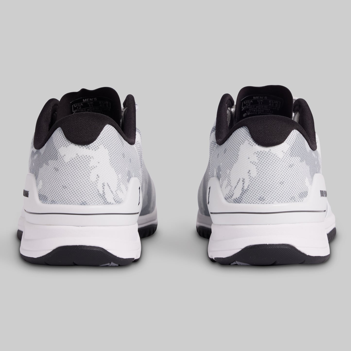 White and black athletic shoes on a gray background