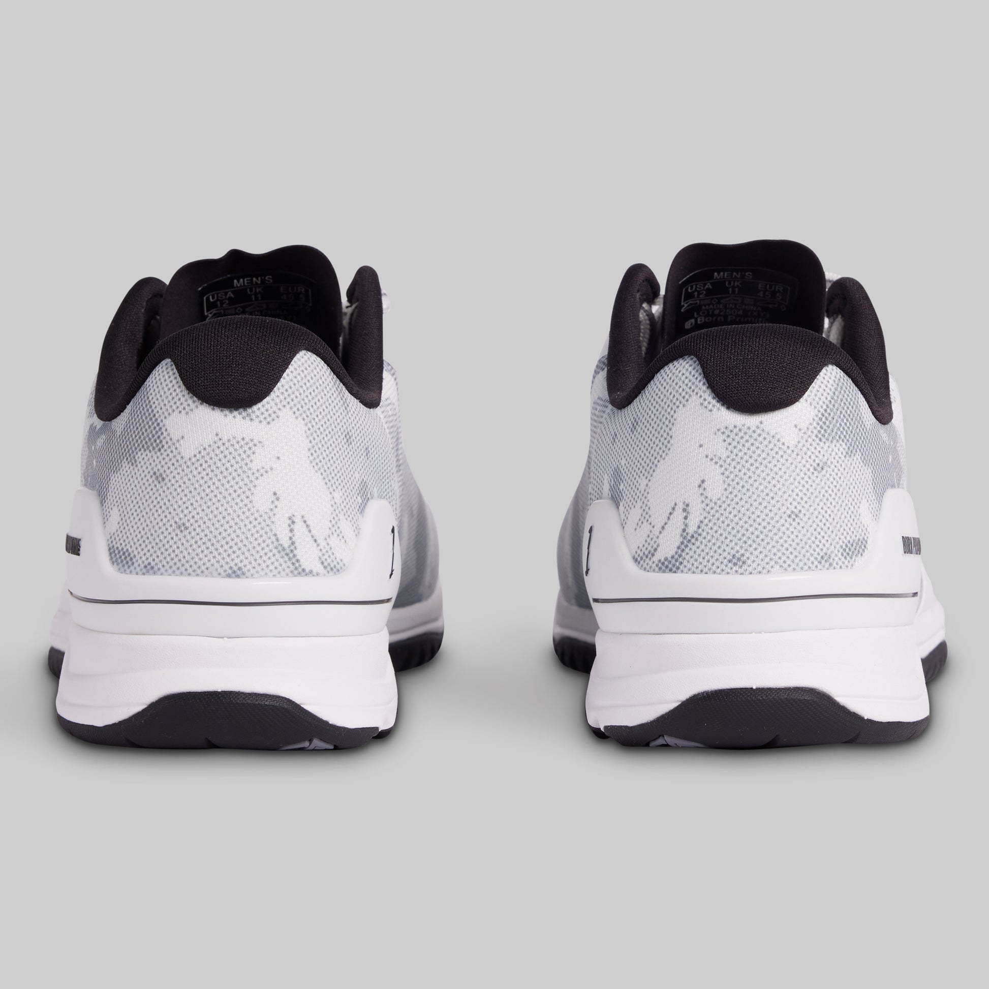 White and black athletic shoes on a gray background