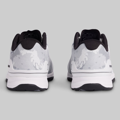 White and black athletic shoes on a gray background