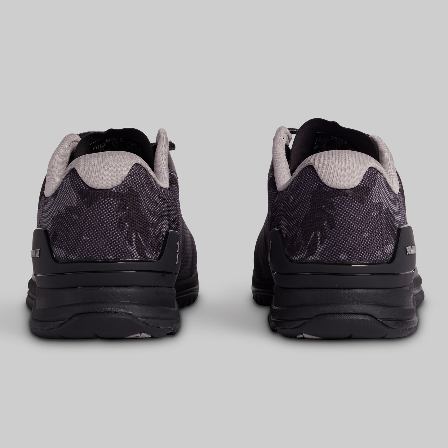 Black and gray athletic shoes on a light gray background