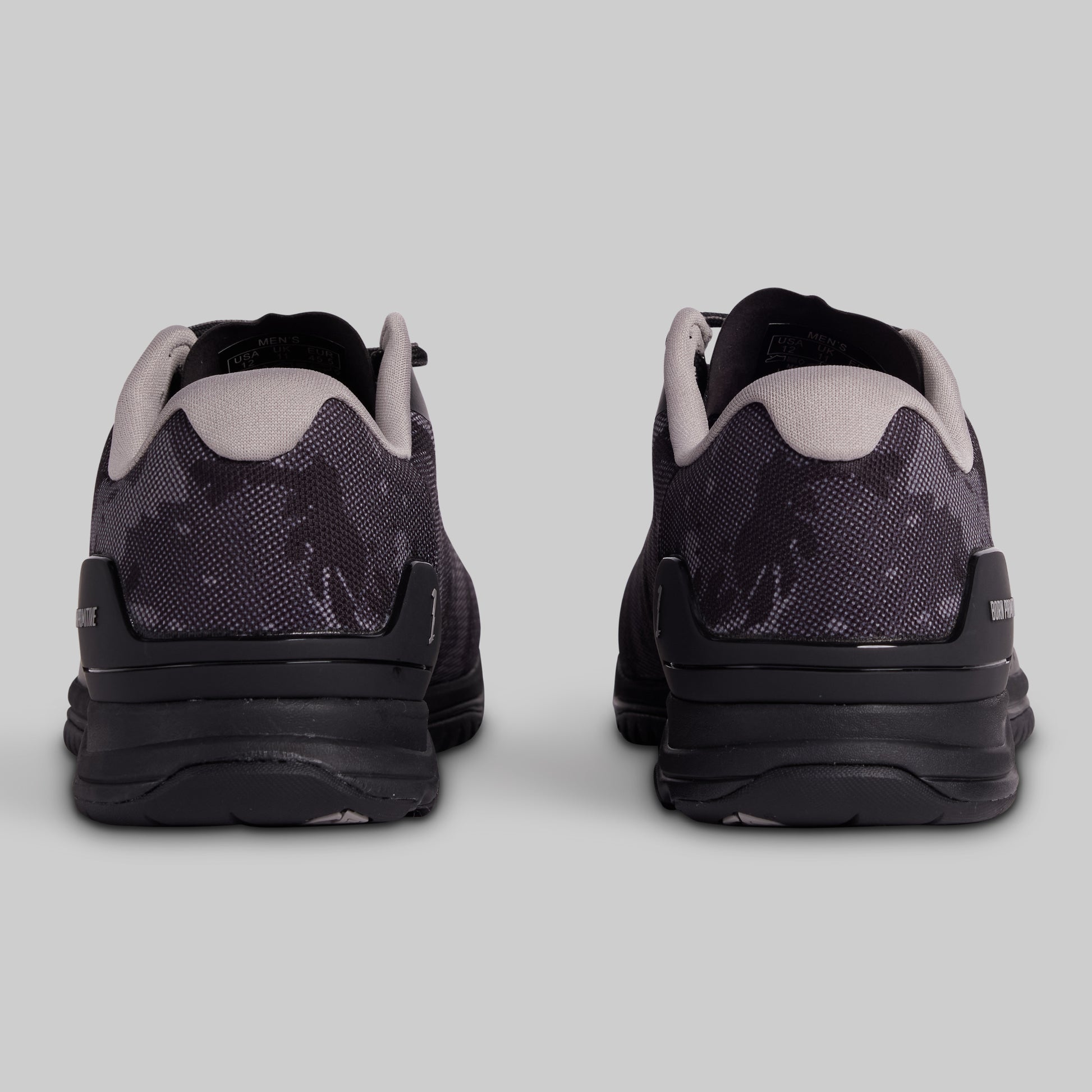 Black and gray athletic shoes on a light gray background