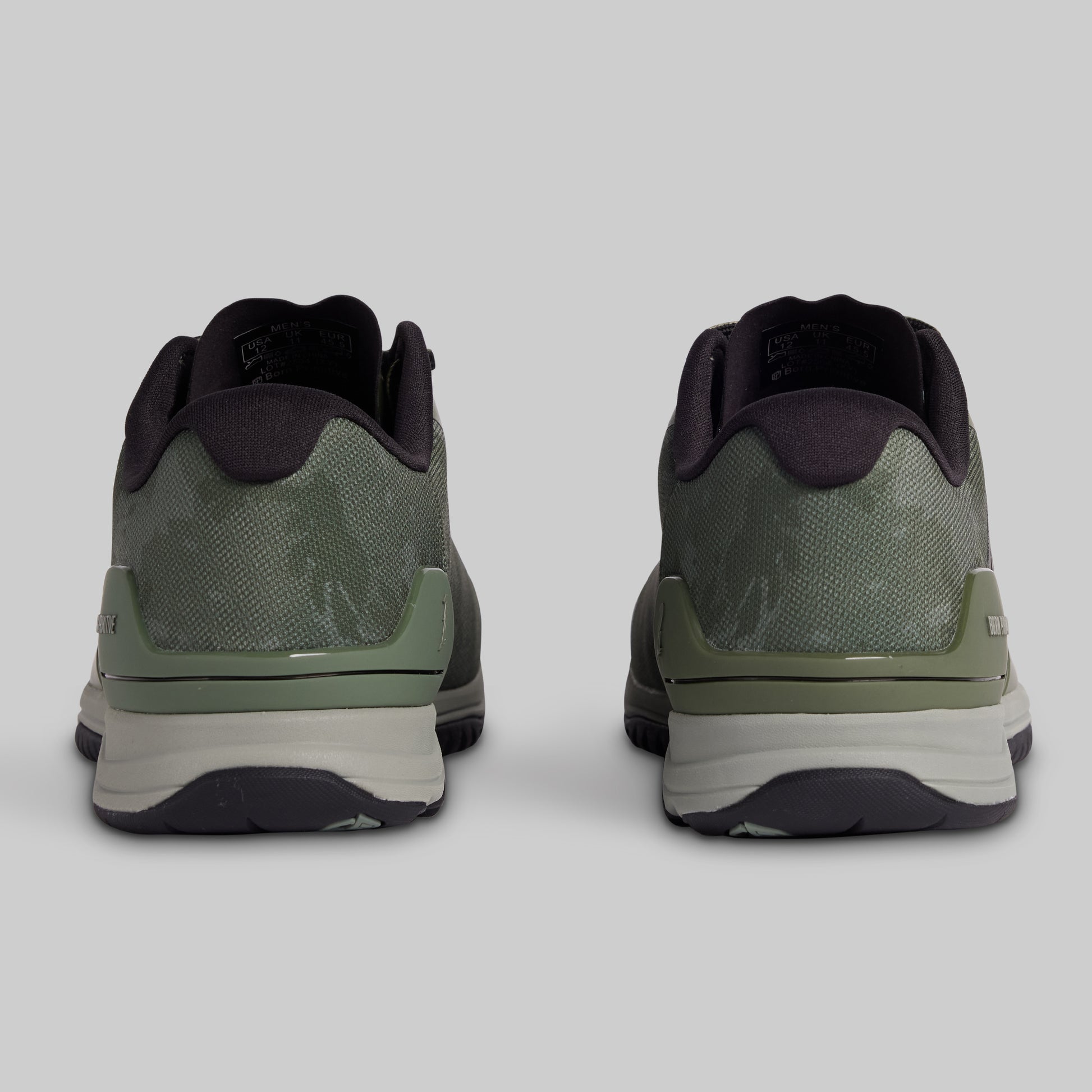 Pair of green athletic shoes on a light gray background