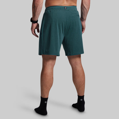 Person wearing teal shorts on a gray background