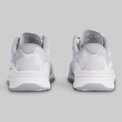 White sneakers with a logo on a light gray background