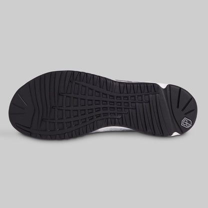 Black sole of a sneaker on a gray background