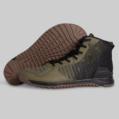 Green and black high-top sneaker with brown sole on a gray background
